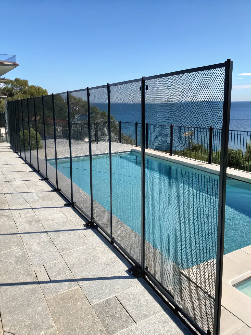 A vinyl fence surrounding a commercial pool, highlighting its durability and low maintenance.