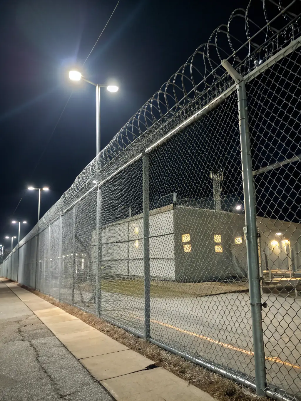 A sturdy chain link fence surrounding a commercial property, providing security and clear boundaries.